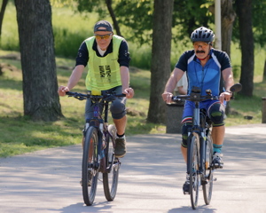 Two bicyclists running on an alley